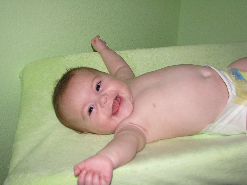 HappyNekidAllie.JPG - I'm stretching out on my changing table.
